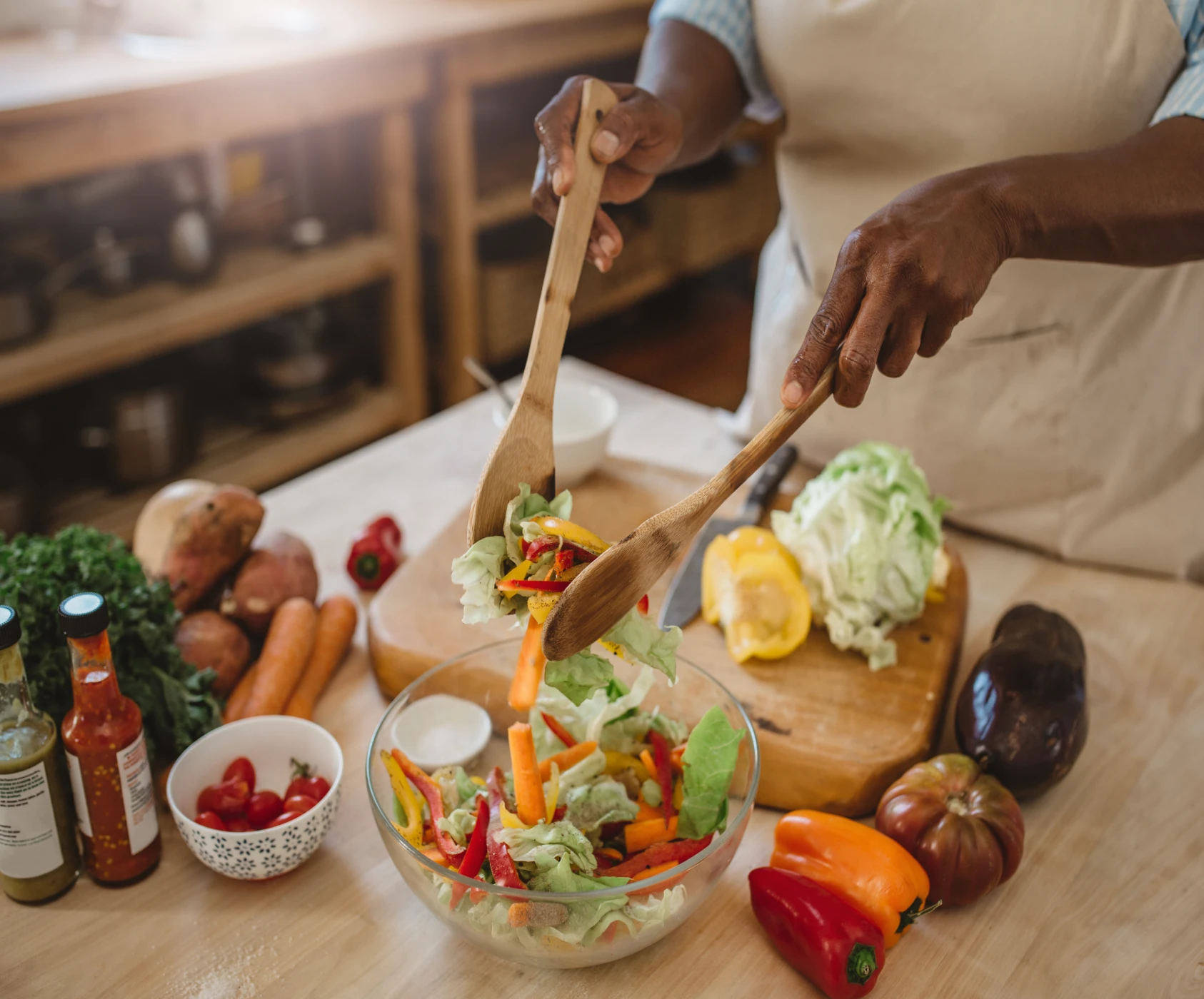 Person preparing fresh vegetable salad
